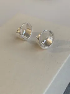 Macro shot of silver S925 sterling silver hoop earrings with clear hallmark engraving