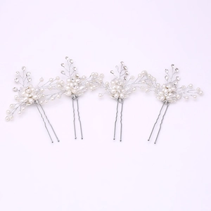 Close-up of bridal hair pins with white pearls and sparkling rhinestones for weddings