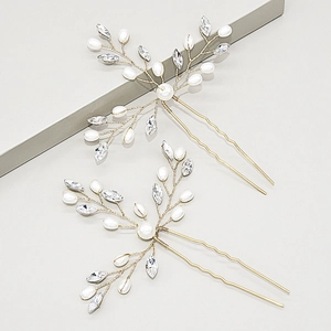 Detail of two-piece bridal hair pins with white pearls and sparkling rhinestones