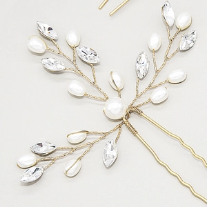 Macro detail of bridal hair pin with handcrafted pearls and marquise crystals