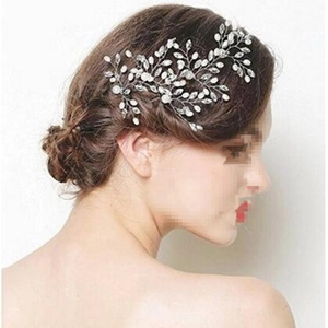 Detail of bridal hair pin with handcrafted pearls and crystals on silver wire