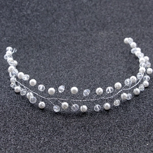 Detailed close-up of handmade bridal hair vine with silver wire, pearls and crystals