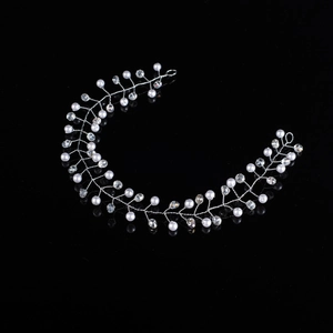 Handmade silver bridal headband with pearls and crystals on a black reflective background