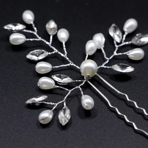 Elegant bridal hair pin with handmade pearls and sparkling crystals in a silver leaf design