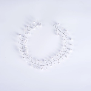 Detailed close-up of handmade bridal hair vine with white pearls and silver crystals