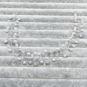 Detail of bridal hair vine with white pearls and crystal beads on silver wire