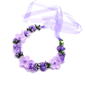 Detail view of purple silk flower crown with elegant organza ribbons and green leaves