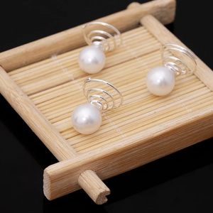 Three elegant bridal pearl hair pins with spiral silver metal clips for wedding hairstyles