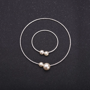 Silver bridal jewelry set with pearls and rhinestones on black background for weddings