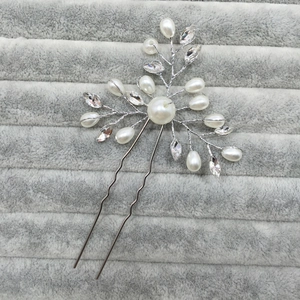 Detail of silver bridal hair pin featuring white pearls and marquise cut crystals