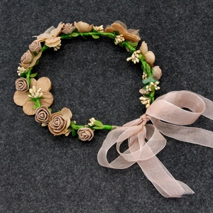 Detail of floral crown with champagne roses and purple organza ribbon for weddings