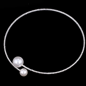 Silver bridal jewelry set with sparkling crystals and twin pearls on black background