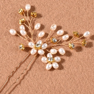 Detailed view of handmade bridal hair pin with pearls and crystals on gold wire