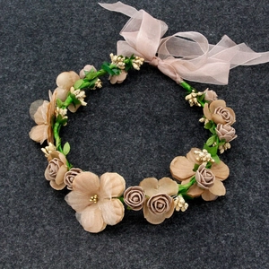 Detail view of artificial rose flower crown with elegant pink chiffon ribbon tie