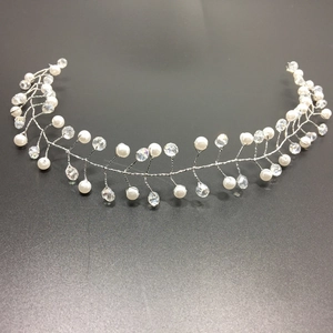Detail of silver bridal hair vine with handmade white pearls and sparkling crystals