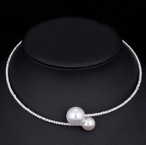 Close-up of elegant bridal choker with sparkling rhinestones and dual pearl accents