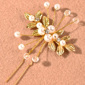 Elegant bridal gold leaf hair pins set with white pearls and crystals for wedding hairstyles