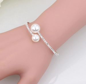 Silver bridal cuff bracelet with two pearls and sparkling zircon pavé crystal setting