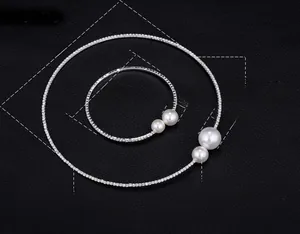 Detail of silver bridal jewelry set with pearls and Austrian crystals on black background
