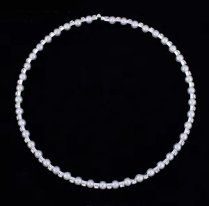 Close-up of 8mm pearl and rhinestone necklace for bridal jewelry set with silver finish