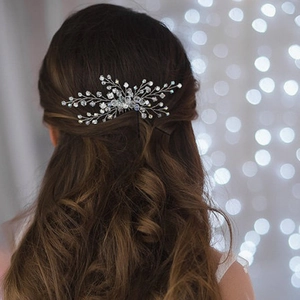 Detailed back view of a silver crystal flower bridal hair pin styled on wavy brown hair