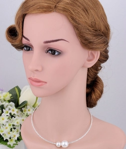 Detail of bridal necklace featuring double pearls and shimmering rhinestone chain