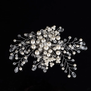Macro view of handmade bridal hair comb with pearls and crystals on silver wire