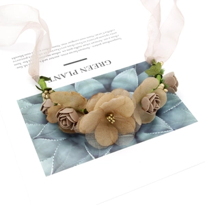 Detail of floral crown with fabric roses and daisies on a vine base for weddings