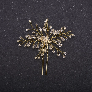 Detailed macro view of handmade gold wire flower hair pin with sparkling crystal beads