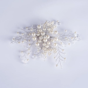Detailed view of silver wire wedding hair comb with white pearls and crystal beads