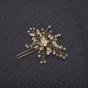 Macro view of handmade gold floral hair pin with crystal beads on a starry background