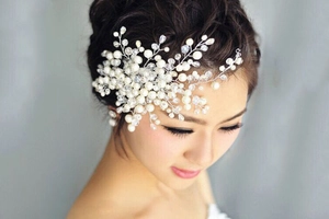 Detailed shot of handmade bridal hair comb with pearls and crystals on a hair bun