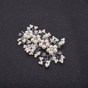 Handmade bridal hair comb with white pearls and crystals on a silver wire and black background