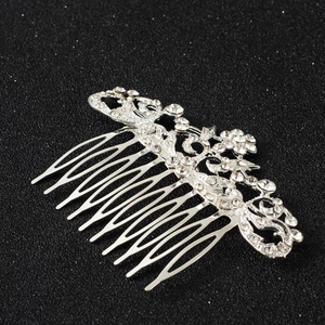 Silver floral bridal hair comb with rhinestones on a sparkling black background