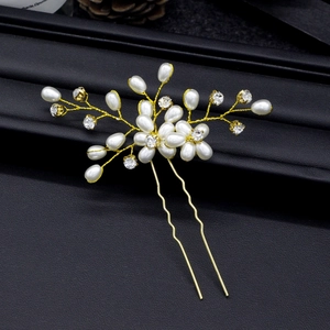 Macro detail of handmade bridal hair pin with pearls, crystals and gold wire branches