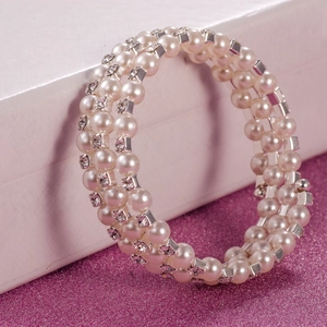 Detailed macro view of 6mm double-layer pearl elastic bracelet with rhinestone dividers