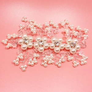 Detail of bridal hair comb with pearls and crystals on a romantic pink background