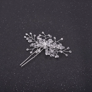 Detailed macro view of handmade silver floral hair pin with sparkling crystal beads