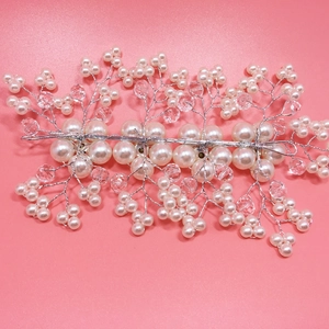 Macro shot of bridal hair vine with white pearls and clear crystals on silver wire