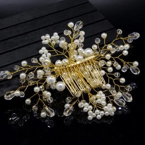 Detailed macro view of handmade gold wire hair comb with white pearls and clear crystal beads