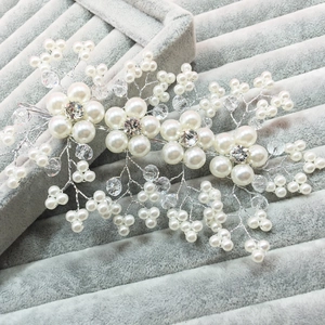 Handmade bridal hair comb featuring white faux pearls and crystal floral vine patterns