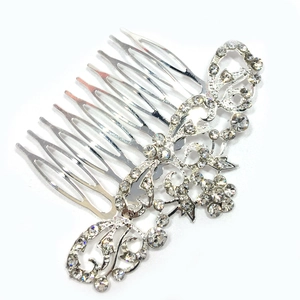 Detail view of bridal hair comb with silver flower patterns and sparkling rhinestones