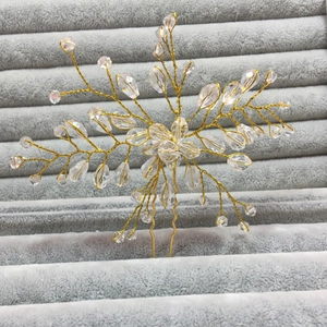 Detail of luxury bridal hair pin with crystal flowers and gold wire handmade design