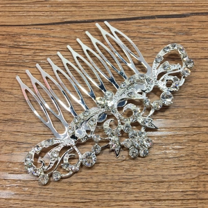 Detailed view of silver bridal hair comb with rhinestones and floral alloy patterns