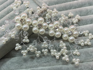 Detail of silver bridal hair comb with handmade pearls and crystal flower accents