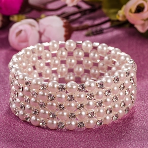 Detailed close-up of 5-layer stretch bracelet with white pearls and sparkling rhinestones