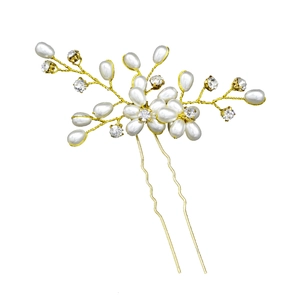 Detailed view of handmade bridal hair pin with pearls, crystals and gold wire flowers