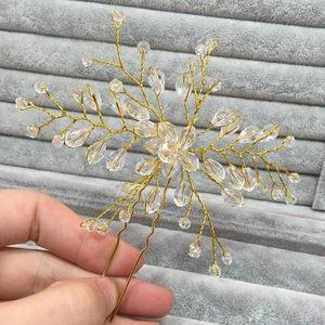 Detailed close-up of handmade gold bridal hair pin featuring clear faceted crystal beads