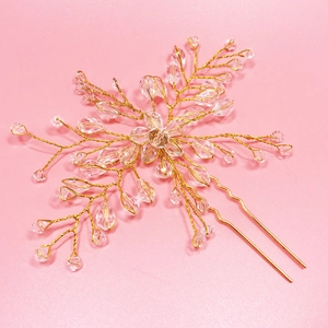 Detail showing handcrafted gold alloy wire branches with clear teardrop crystals for weddings