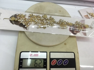 Close-up of golden leaf and flower bridal headpiece with crystals weighing 62g